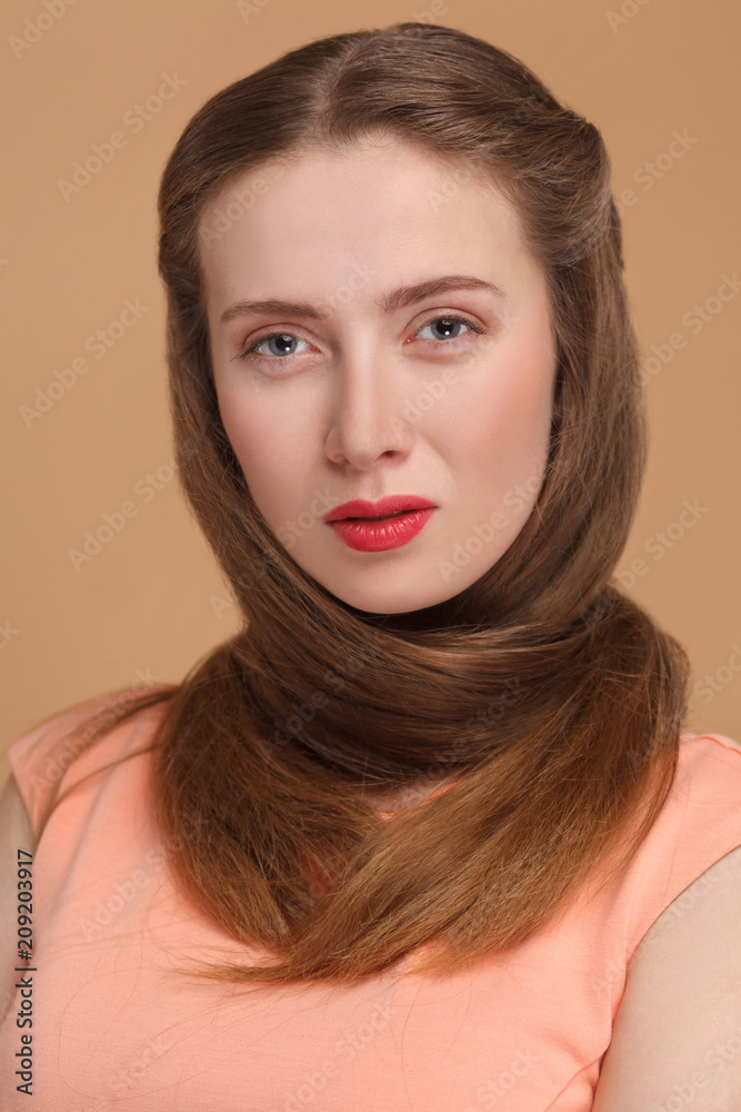 woman wraped hair around her neck and looking at camera.
