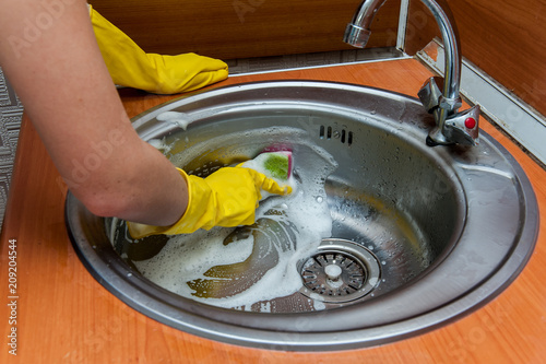 wash the sink with a dishwashing detergent