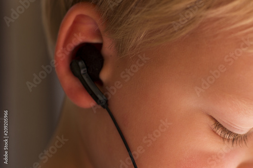 Close up portrait of toddler boy with ear-phones