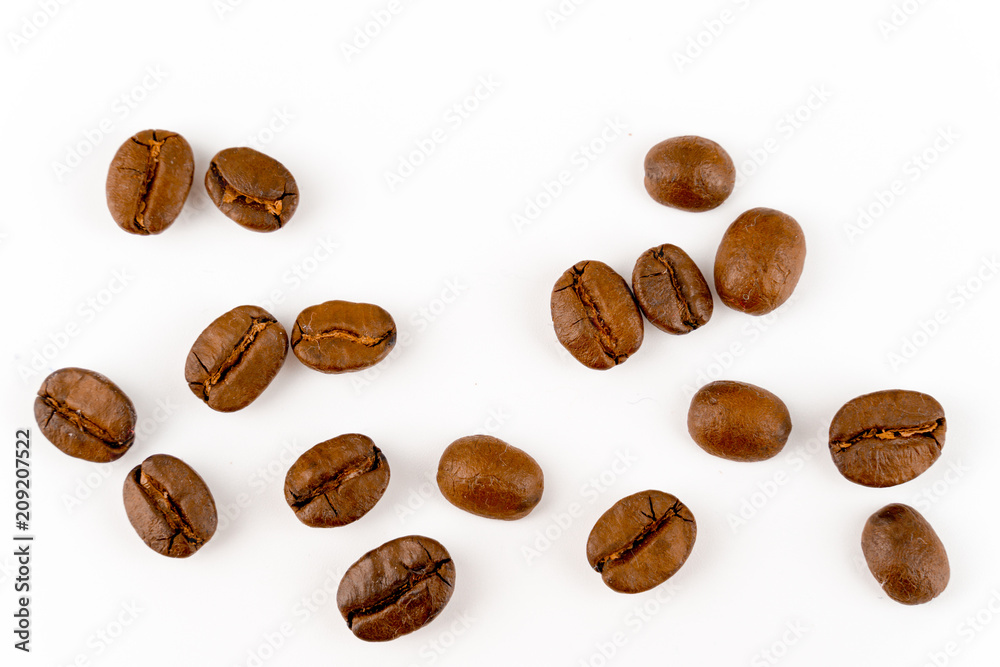 close up of medium or dark roasted coffee beans isolated on white background, can be used as a background or graphic object in your ads. close up of medium or dark roasted coffee beans isolated on white background, can be used as a background or graphic object in your ads.