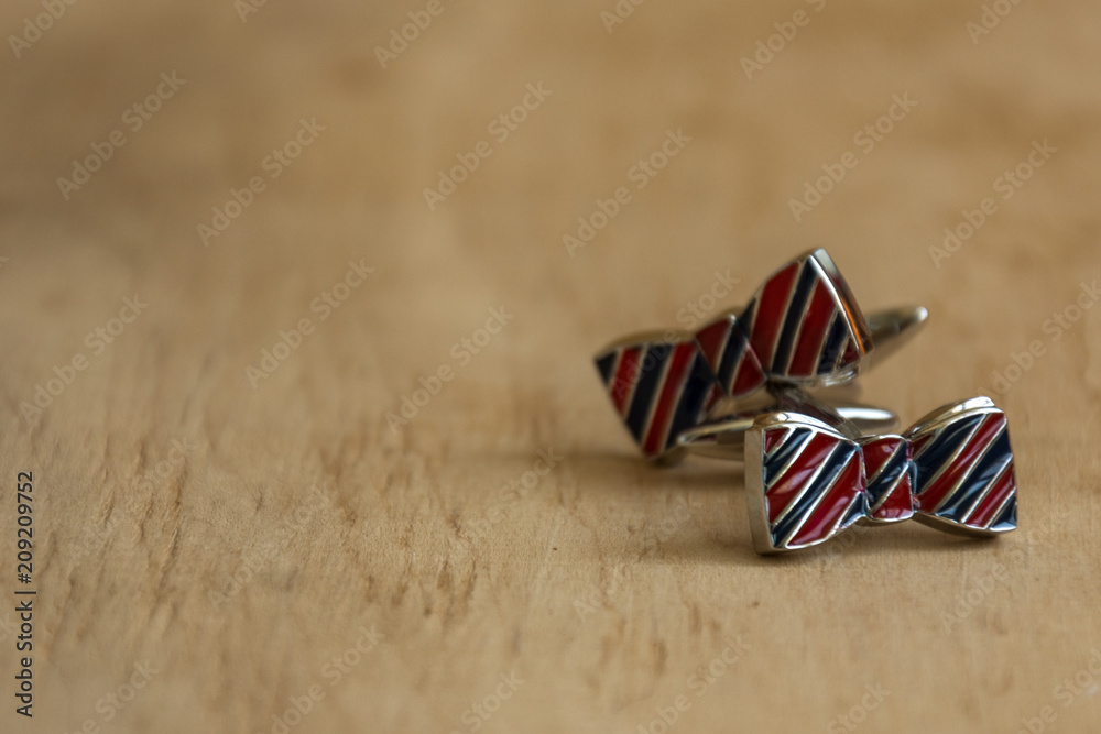 Pair of cufflinks on wooden background. Copy space. Mockup for design. Pair of cufflinks on wooden background. Copy space. Mockup for design.
