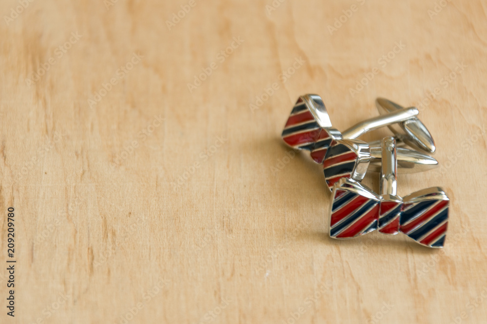 Pair of cufflinks on wooden background. Copy space. Mockup for design. Pair of cufflinks on wooden background. Copy space. Mockup for design.