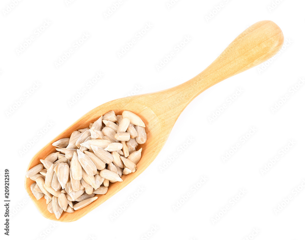 Sun flower seed on wood scoop isolated on white background Sun flower seed on wood scoop isolated on white background