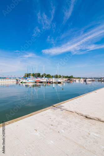 Sailboat harbor, many beautiful moored sail yachts in the sea port, modern water transport, summertime vacation, luxury lifestyle and wealth concept