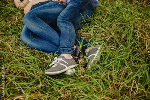 Couple of lovers with green sneakers and standing jeans