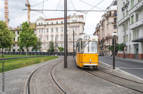 Yellow tram on line 2 approaching Parliament square. Line 2 of Budapest is deemed to be one of the most beautiful tram lines in the world.