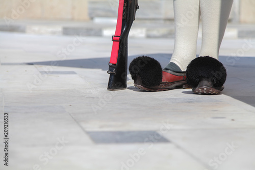  Close-up of the legs changing the guard of Greece in shoes with pumples. photo