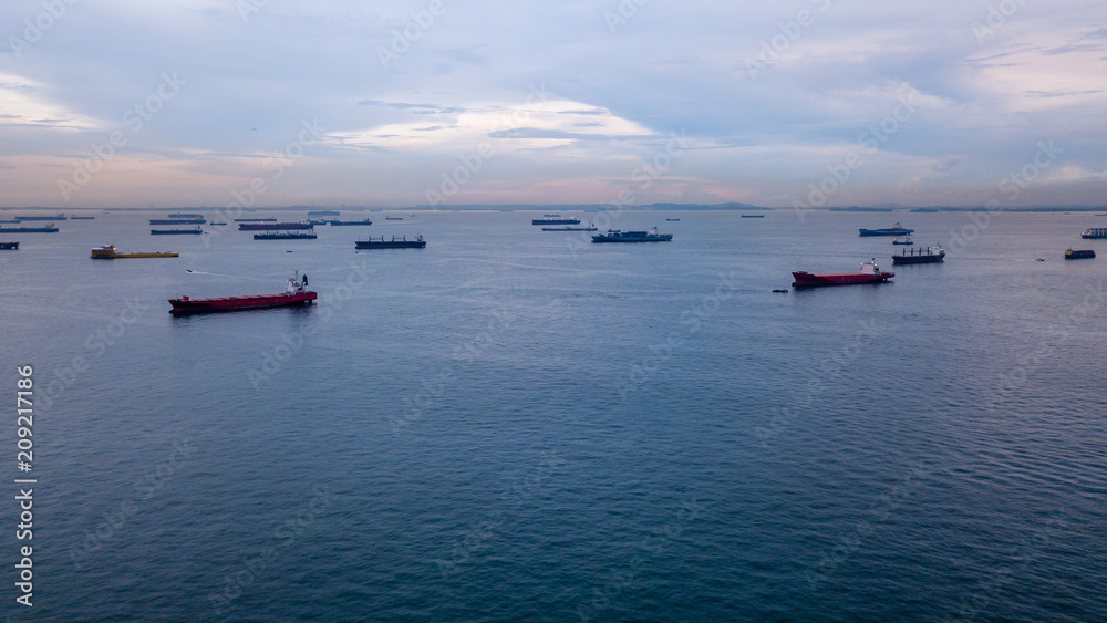 Aerial view of container ships in the Singapore Strait at dusk