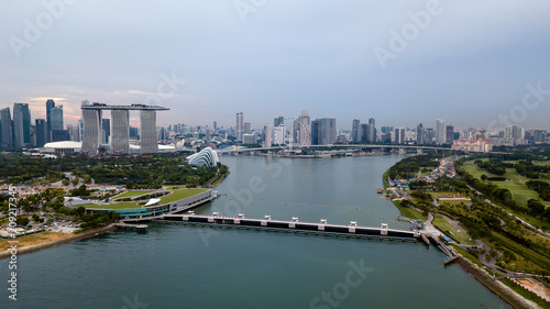 Aerial drone view of Singapore Marina Barrage with ships waiting out to sea