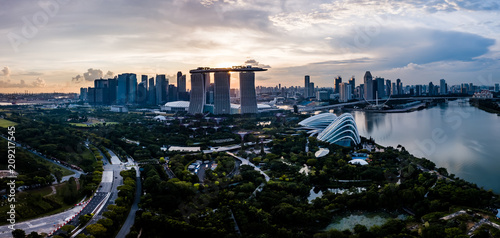 Photography Aerial drone view of Singapore city skyline at sunset