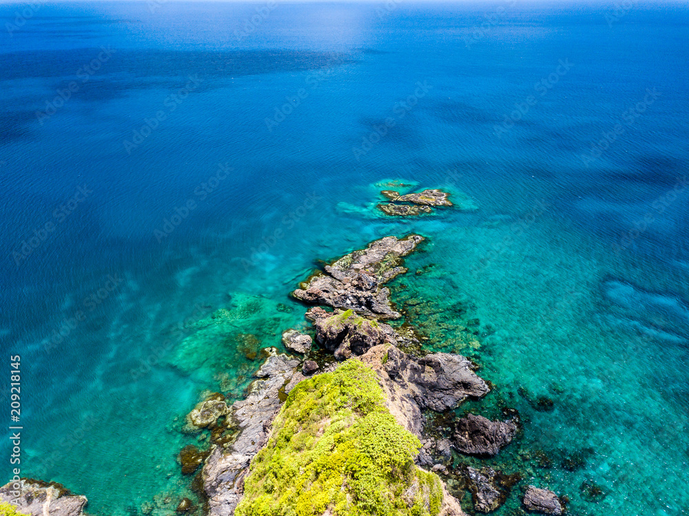 Aerial drone view of a tropical coral reef and small island