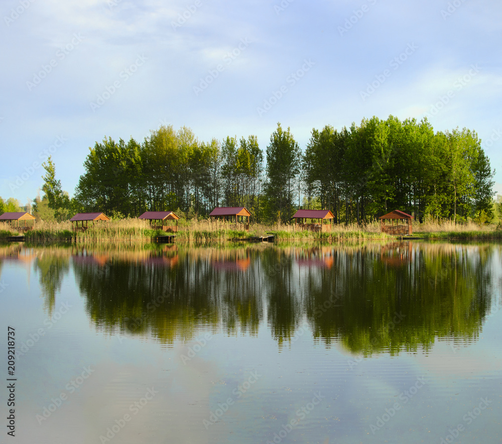 Fototapeta premium reflection of the forest and the blue sky in the lake