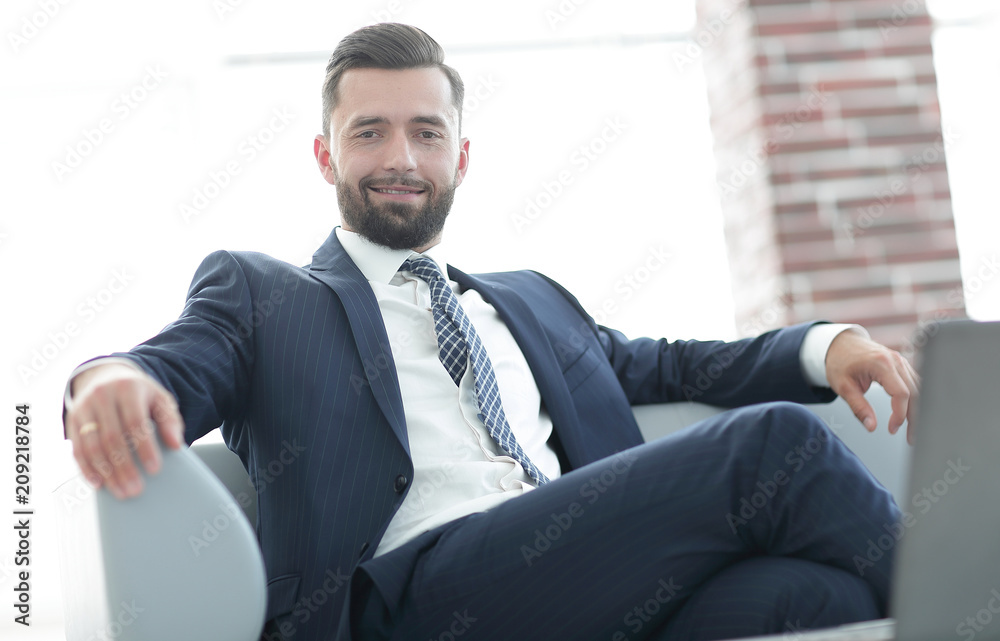 Portrait of a successful businessman sitting in the office lobby. Portrait of a successful businessman sitting in the office lobby.