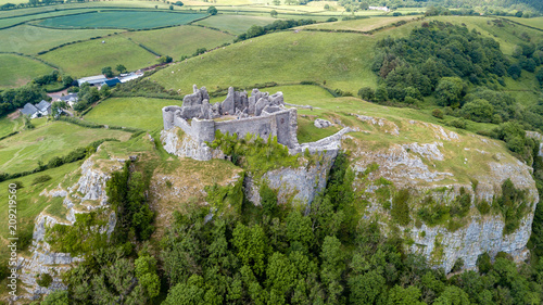 Aerial view of a ruined castle overlooking rural farmland in Wales (Britain) photo