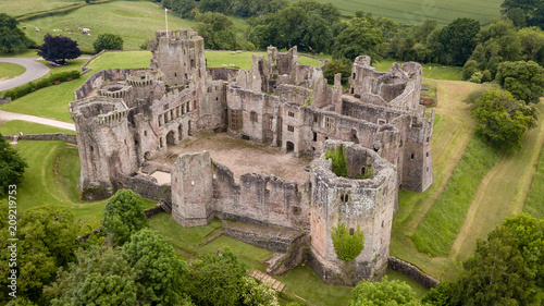 Aerial view of the ruins of a large medieval castle (Raglan Castle, South Wales, UK)