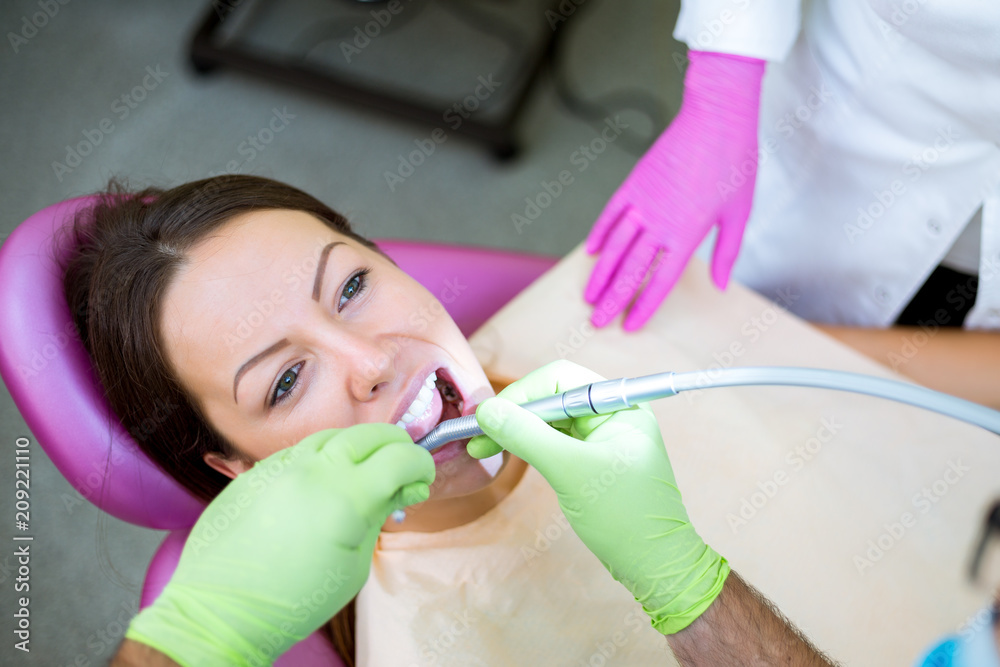 Dentist check up and repair tooth of young girl Dentist check up and repair tooth of young girl