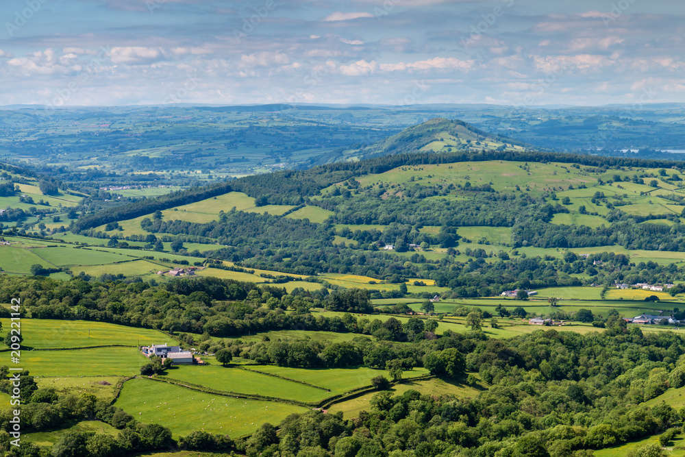 Aerial view of green farmland and fields in the rural Welsh countryside