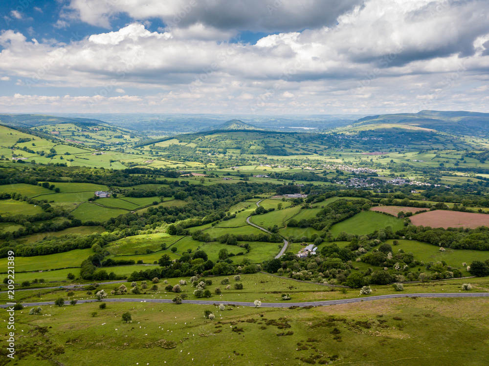 Aerial view of green farmland and fields in the rural Welsh countryside