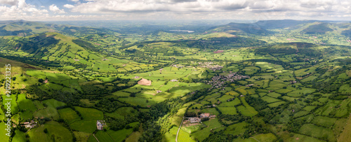Panoramic aerial view of green farmland and fields in the rural Welsh countryside