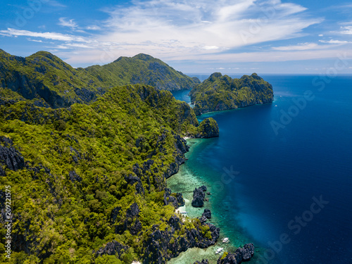 Aerial drone view of spectacular tropical scenery with towering cliffs, jungle and pristine sandy beaches © whitcomberd