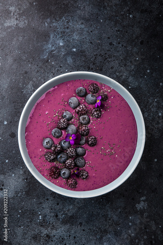 delicious blueberry smoothie bowl with frozen berries photo