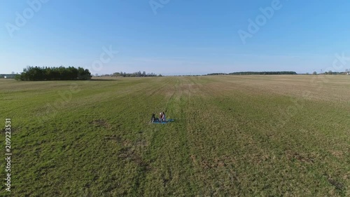 Wallpaper Mural Girls sitting on the mats on the grass in the park. Flight above field. Torontodigital.ca