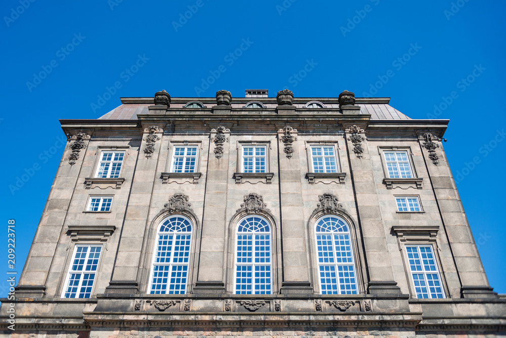 low angle view of historical Christiansborg Palace and clear blue sky, copenhagen, denmark