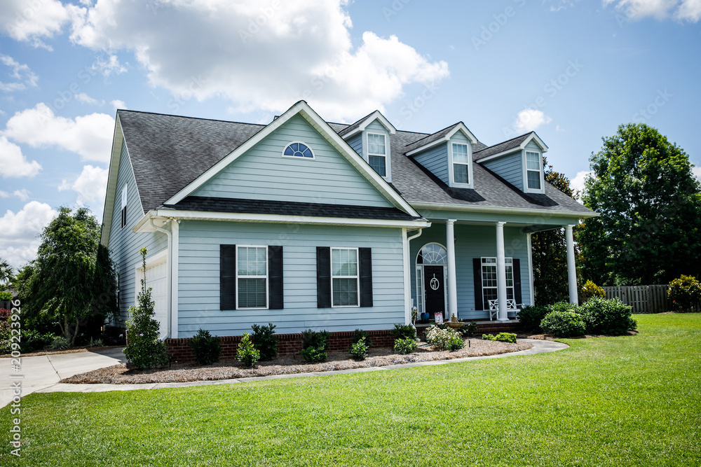 Blue Traditional Siding House Home in Suburbs Front Facing with Curb Appeal Blue Traditional Siding House Home in Suburbs Front Facing with Curb Appeal