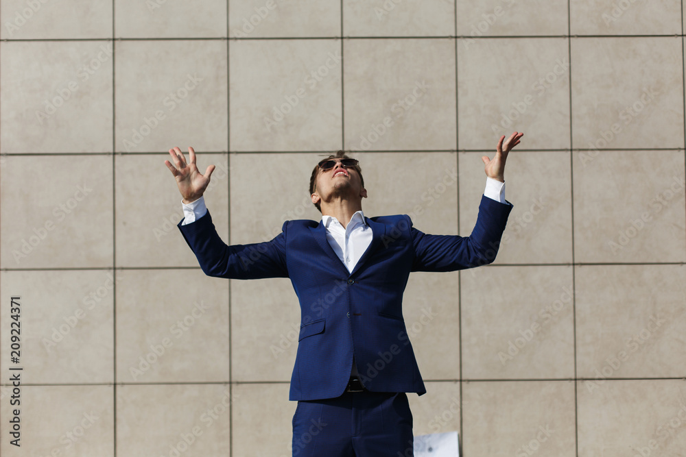 Young businessman throughs away papers standing on the street Young businessman throughs away papers standing on the street