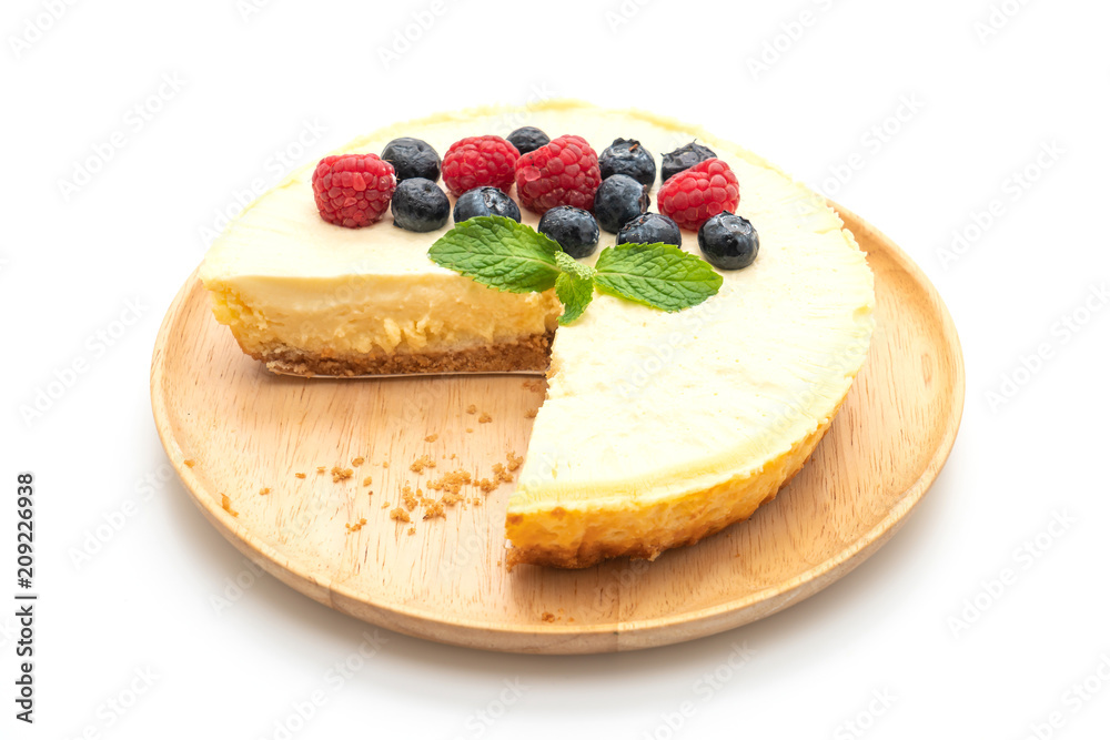 Homemade cheesecake with raspberries and blueberries on white background Homemade cheesecake with raspberries and blueberries on white background