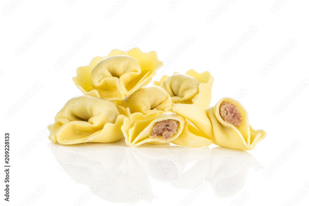 Raw tortellini Italian pasta stuffed with meat isolated on white background.