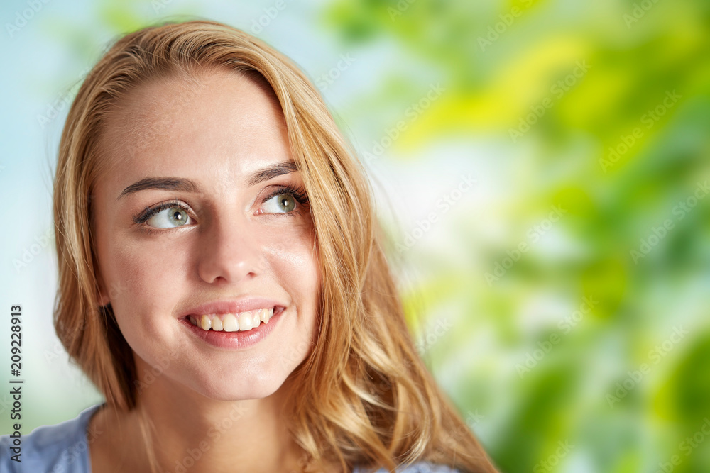people and portrait concept - happy woman face over green natural background people and portrait concept - happy woman face over green natural background