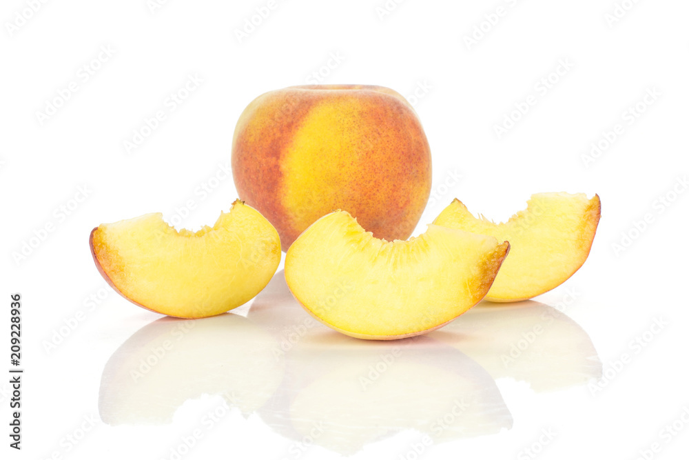One yellow peach and three slices isolated on white background. One yellow peach and three slices isolated on white background.