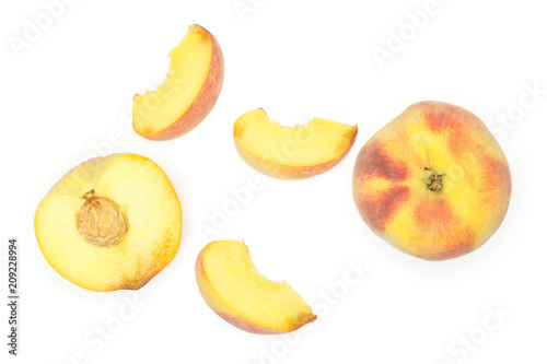 One yellow peach, a section half and three slices, flatlay, isolated on white background.