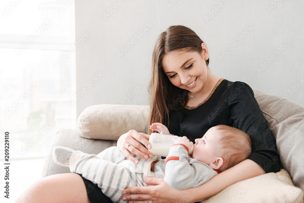 Happy young family. Mother feeds her little child. Happy young family. Mother feeds her little child.