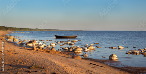 Lonely stone in the water - peaceful evening seaside