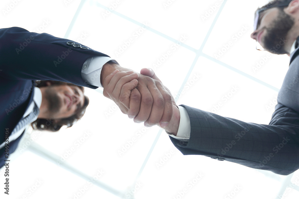 Two business people are holding hands to business cooperation.