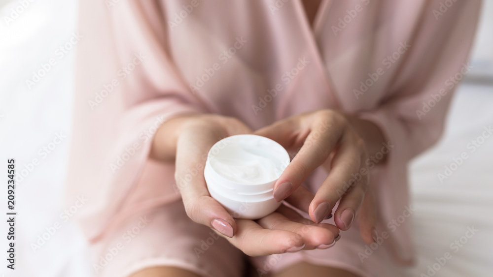 A Woman Holding Skin Cream A Woman Holding Skin Cream