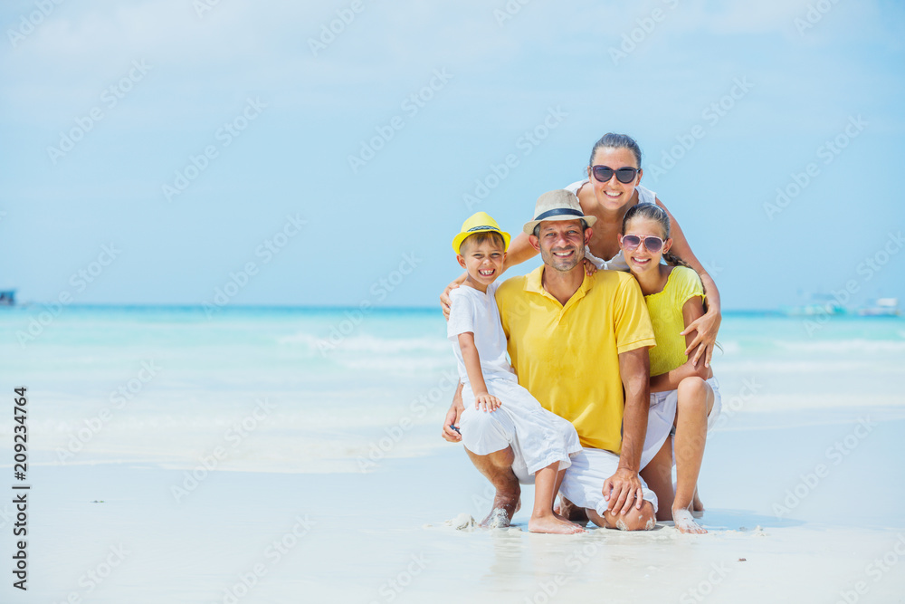 Family of four having fun at the beach