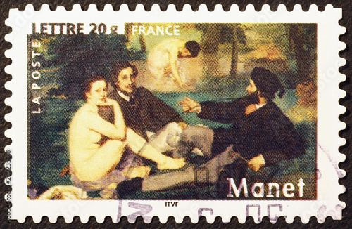 Masterpiece Dejeuner sur l'herbe by Manet on postage stamp photo