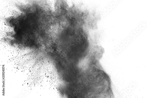 Black powder explosion. Closeup of black dust particles splash isolated on background.
