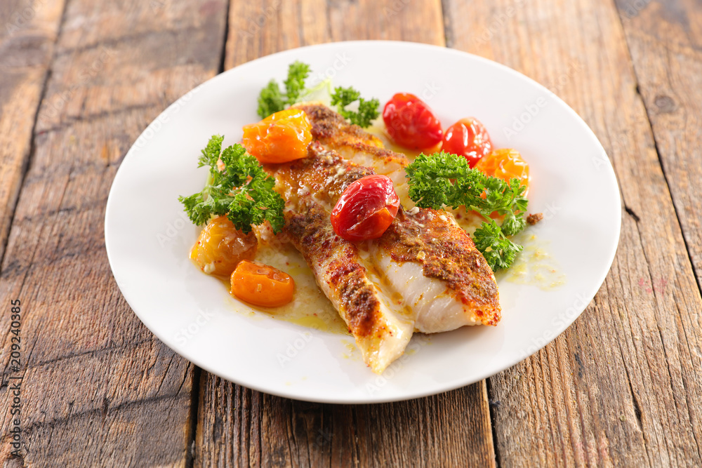 fish fillet with baked tomato