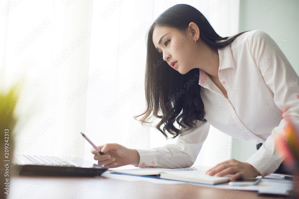 Beautiful young Asia woman working in office Beautiful young Asia woman working in office
