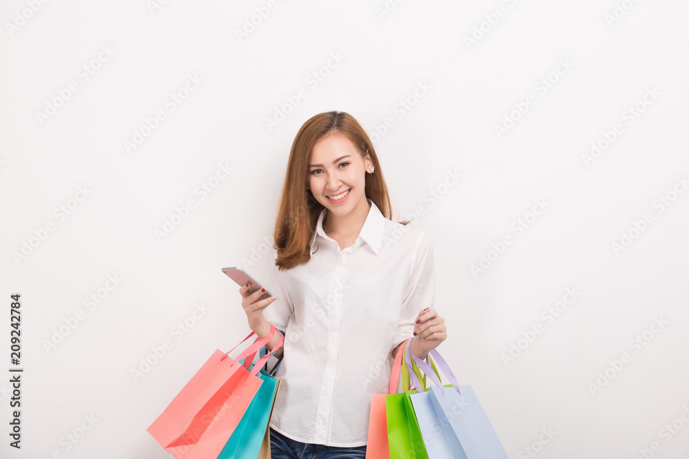 Very happy beautiful young woman in casual clothing with shopping bags Very happy beautiful young woman in casual clothing with shopping bags
