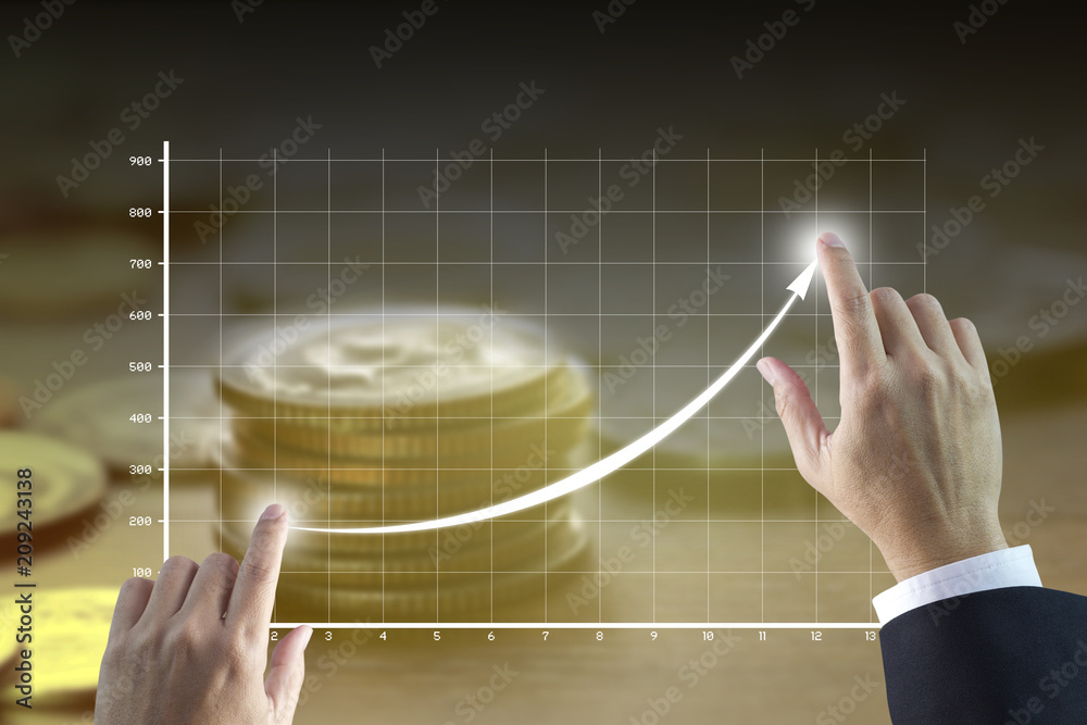 Businessman’s hands drawing a line graph showing of business growth and ...