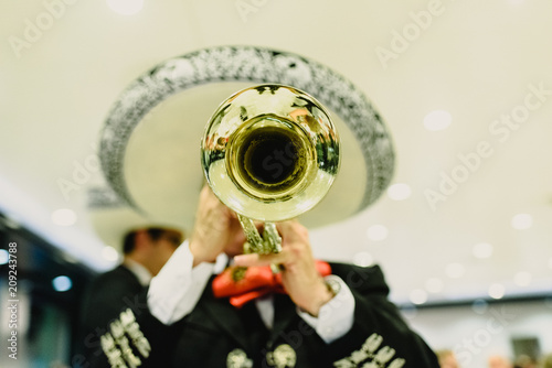 Mexican musician with his trumpet and guitars photo