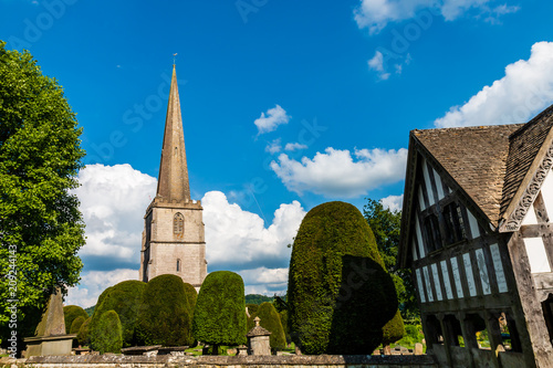 An ancient church and graveyard in the scenic Cotswolds area of England on a summers day  Painswick 