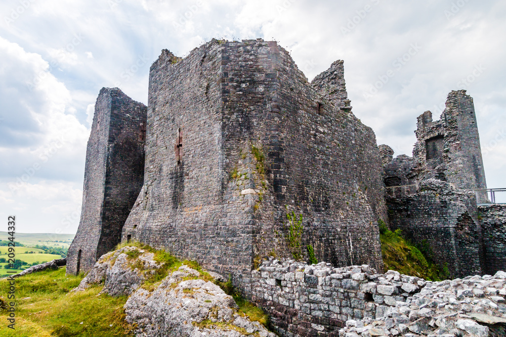 Ruins of an ancient medieval castle on a hillside (Carreg Cennen, Wales, UK)