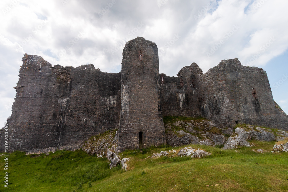 Ruins of an ancient medieval castle on a hillside (Carreg Cennen, Wales, UK)
