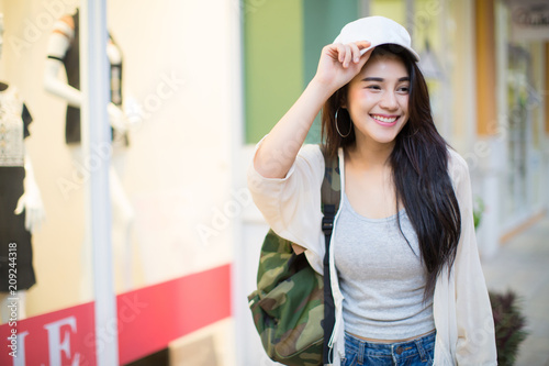 Asia woman walking and using a smart phone in the street